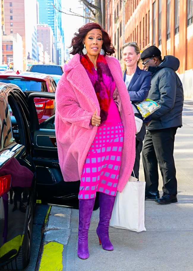 Gayle King wearing purple Christian Louboutin boots in New York City on Feb. 18, 2025.