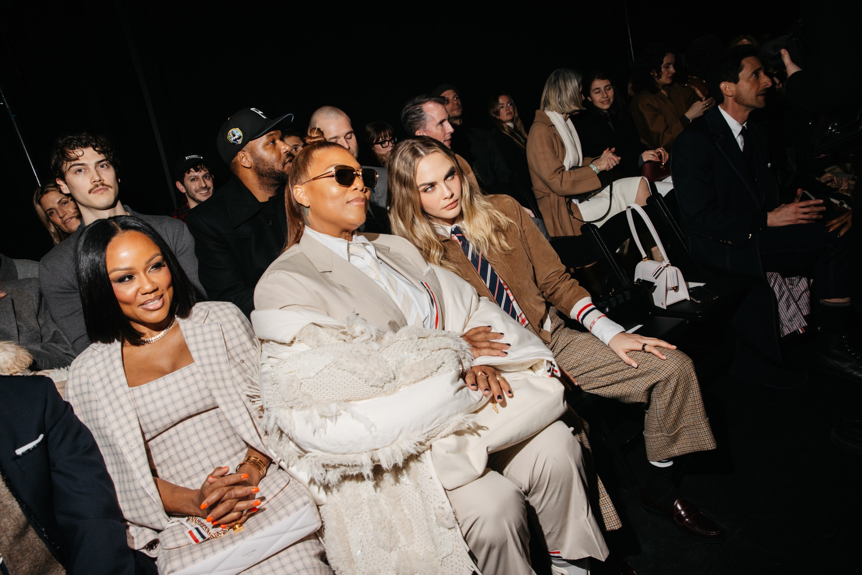 Eboni Nichols, Queen Latifah, Cara Delevingne at the Thom Browne Fall RTW 2025 fashion show as part of New York Fashion Week held at The Shed on February 11, 2025 in New York, New York.