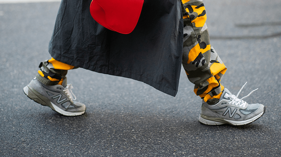 Person wearing gray sneakers and camo pants