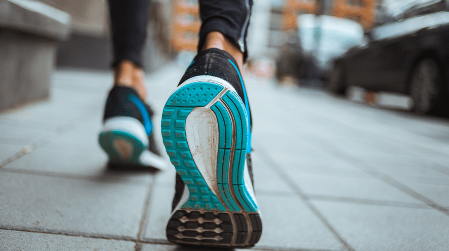 close up of the bottom of a person wearing running shoes